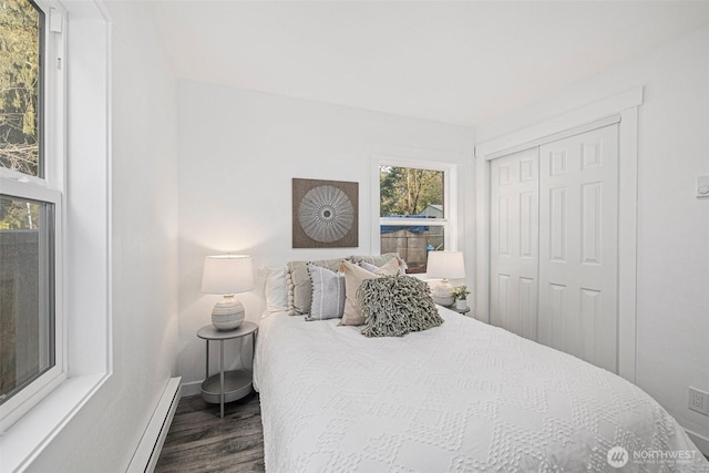 bedroom featuring dark wood-type flooring, a closet, and baseboards