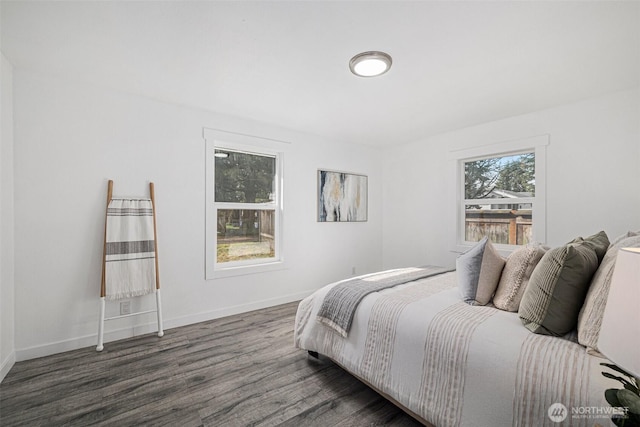 bedroom featuring baseboards and dark wood finished floors