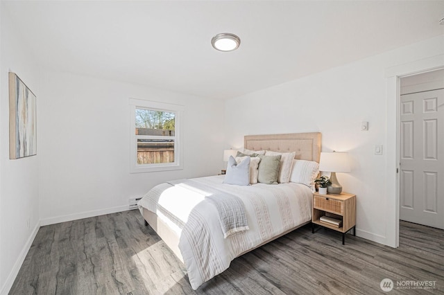 bedroom featuring wood finished floors and baseboards