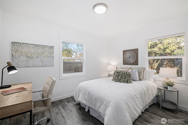 bedroom with baseboards and wood finished floors