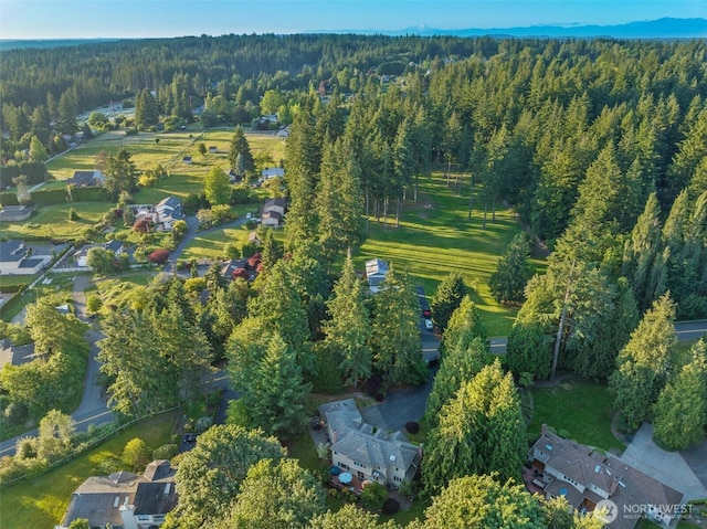 bird's eye view featuring a wooded view