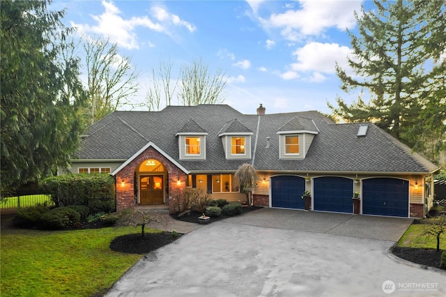 view of front of property with a garage, brick siding, a shingled roof, concrete driveway, and a front yard