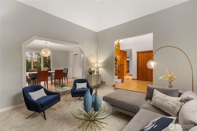 living area with an inviting chandelier, visible vents, stairs, and baseboards