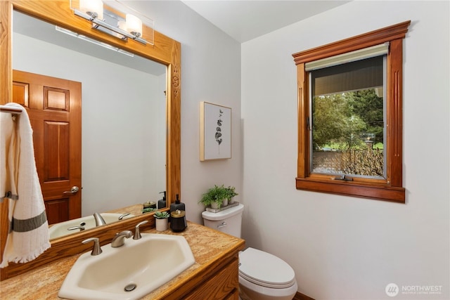 bathroom featuring vanity and toilet