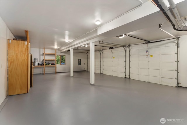 garage with electric panel and a garage door opener