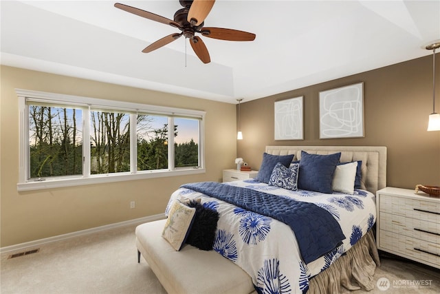 carpeted bedroom with ceiling fan, visible vents, and baseboards