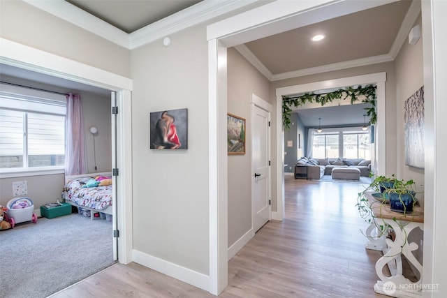 hall featuring light wood-type flooring, baseboards, crown molding, and recessed lighting