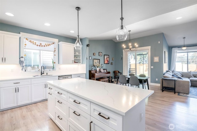 kitchen featuring plenty of natural light, light wood-style flooring, and a sink