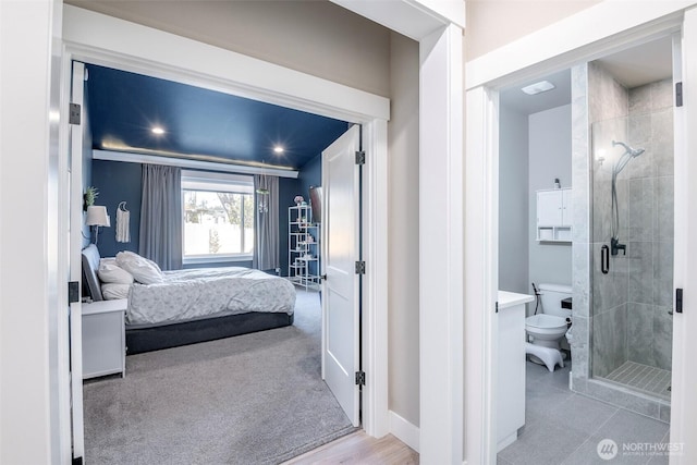 bedroom featuring carpet, connected bathroom, and baseboards