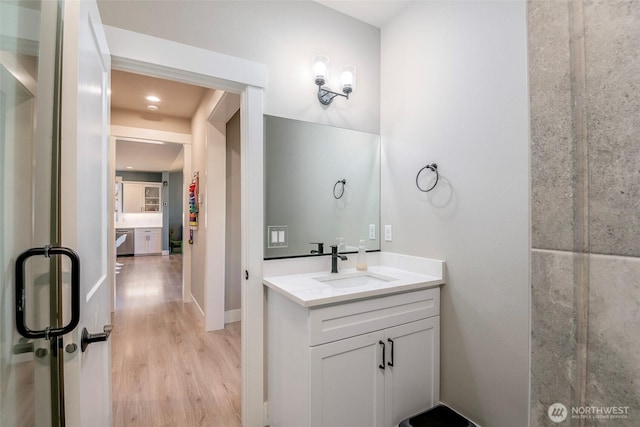 bathroom with wood finished floors and vanity