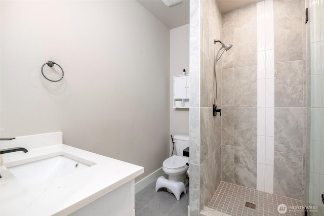 full bath featuring a stall shower, vanity, toilet, and tile patterned floors