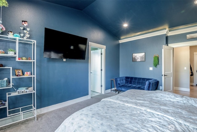 carpeted bedroom with baseboards and vaulted ceiling