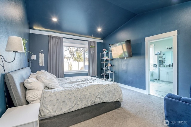 bedroom featuring lofted ceiling, recessed lighting, carpet flooring, ensuite bath, and baseboards