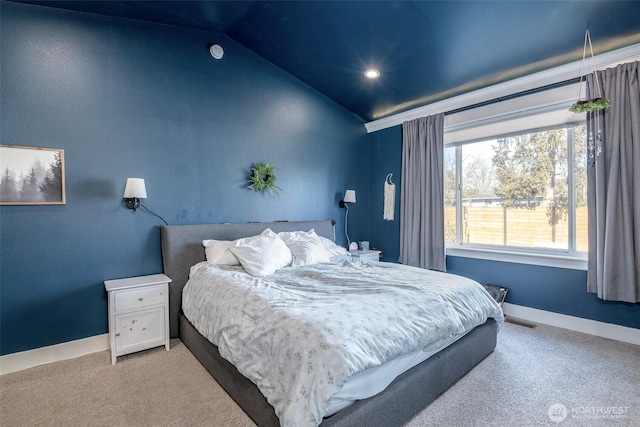 carpeted bedroom featuring visible vents, vaulted ceiling, and baseboards