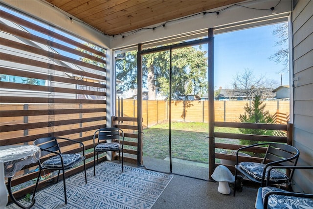 sunroom / solarium featuring wood ceiling