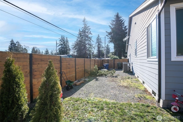 view of yard with cooling unit and a fenced backyard