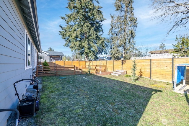 view of yard with a fenced backyard