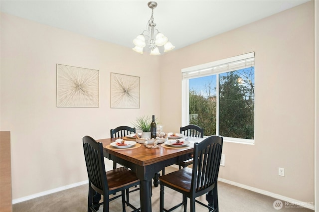 dining area with baseboards, carpet floors, and an inviting chandelier