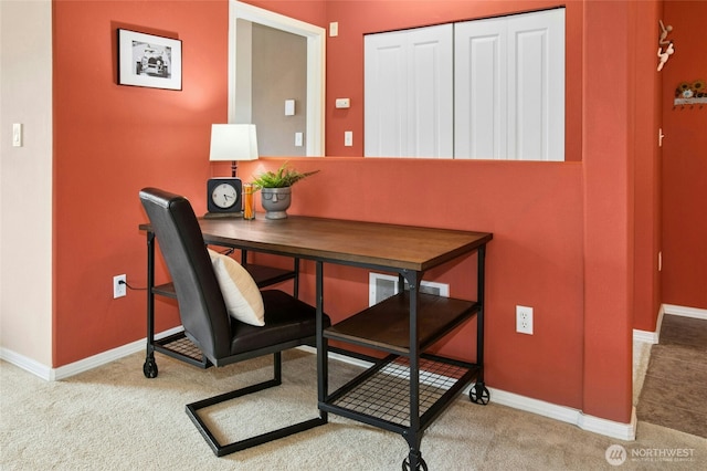 carpeted office featuring baseboards