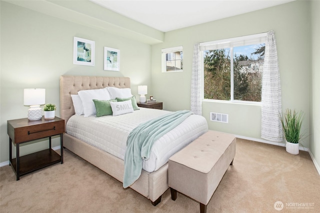 carpeted bedroom with baseboards and visible vents