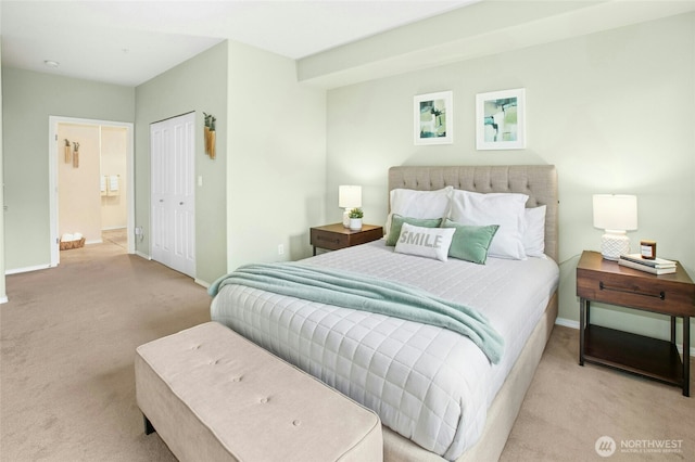 carpeted bedroom featuring a closet and baseboards