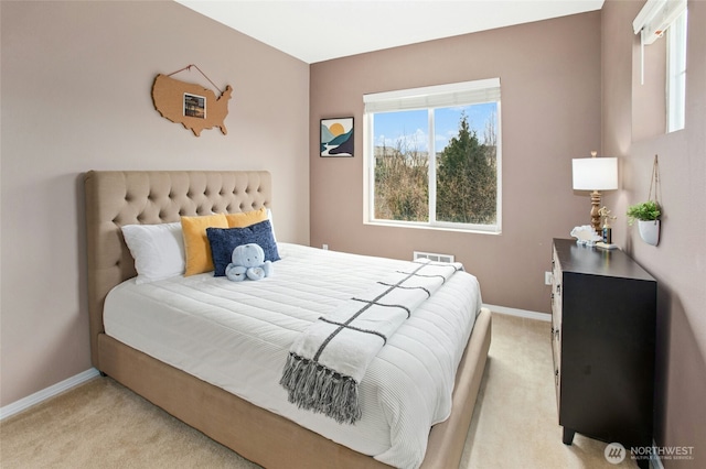 bedroom with visible vents, light colored carpet, and baseboards