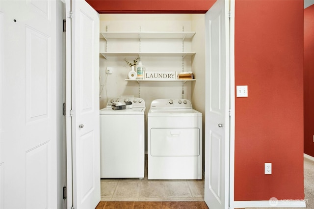 laundry area featuring washer and dryer, laundry area, and light tile patterned floors