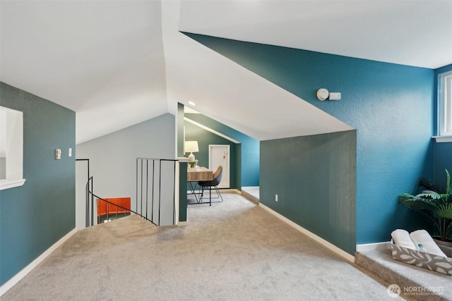 bonus room with lofted ceiling, carpet, and baseboards