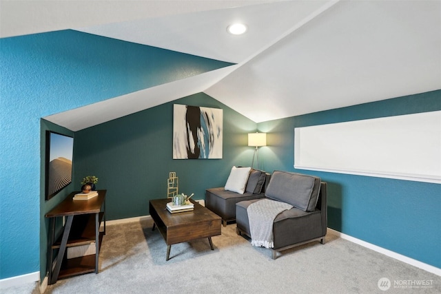 interior space with carpet, baseboards, and vaulted ceiling