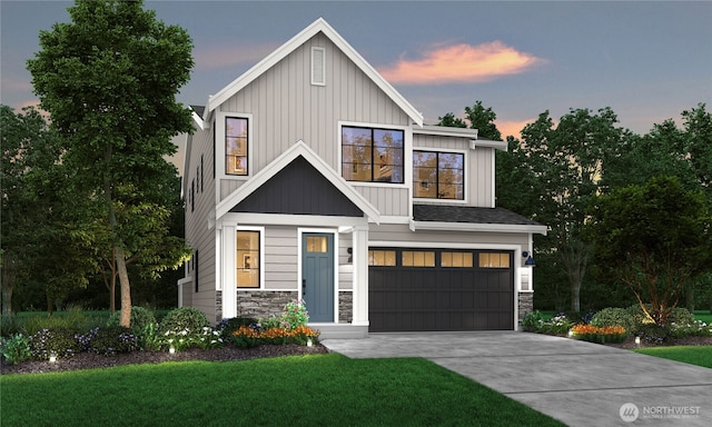 modern farmhouse featuring a lawn, an attached garage, board and batten siding, stone siding, and driveway