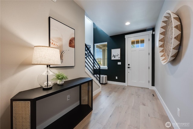 foyer entrance featuring recessed lighting, light wood-style flooring, baseboards, and stairs