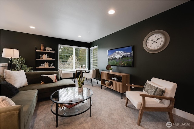 living area featuring recessed lighting and light carpet