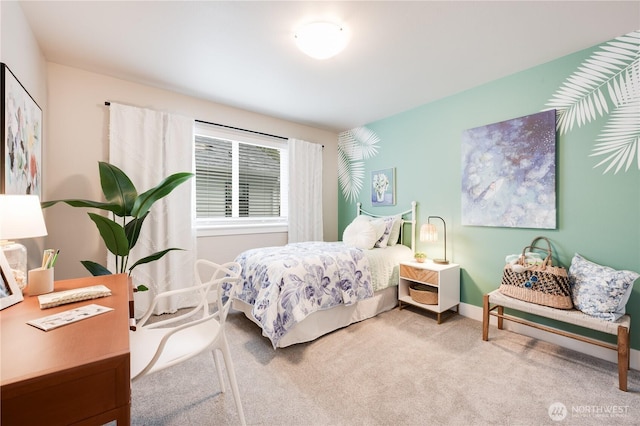 carpeted bedroom featuring baseboards