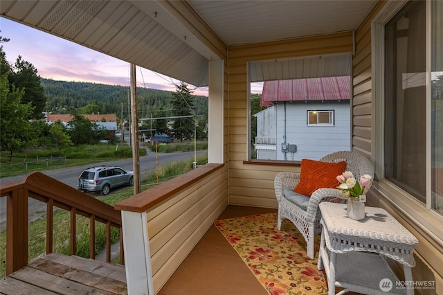 balcony with covered porch and a sunroom