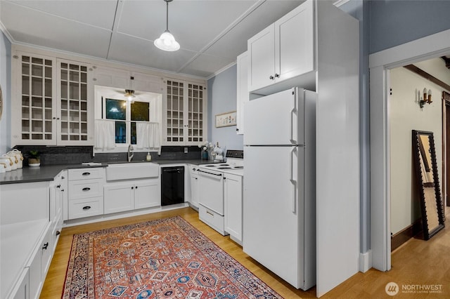 kitchen with light wood-type flooring, white appliances, white cabinets, and a sink