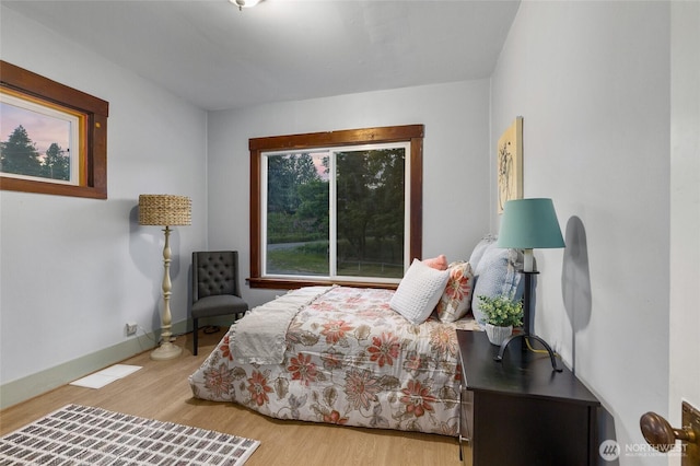 bedroom featuring baseboards and wood finished floors