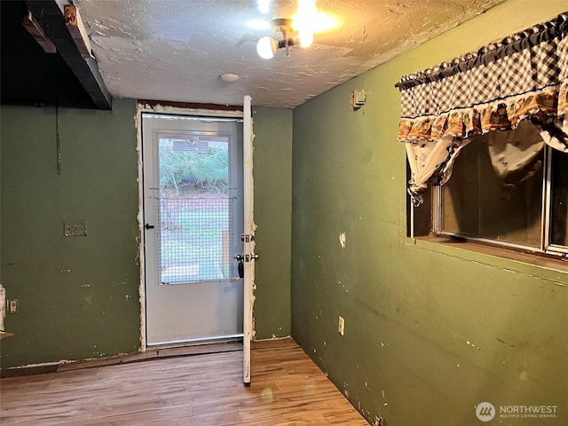 entryway with a textured ceiling and wood finished floors