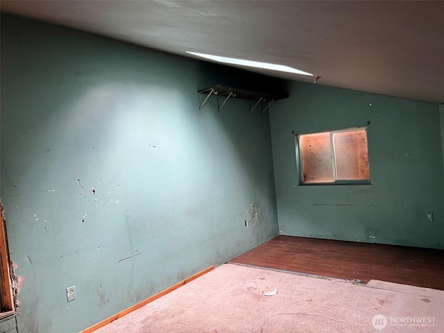 empty room featuring lofted ceiling