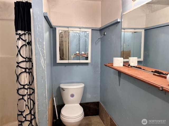 bathroom featuring toilet and a shower with curtain