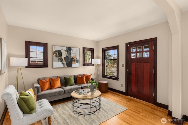 living room featuring baseboards and light wood-style floors