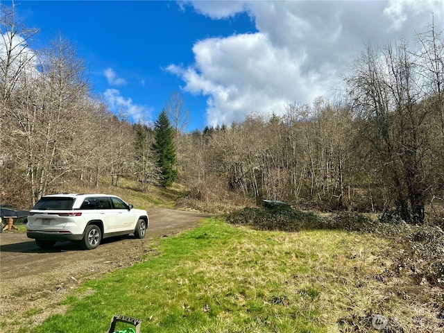 view of road featuring a forest view