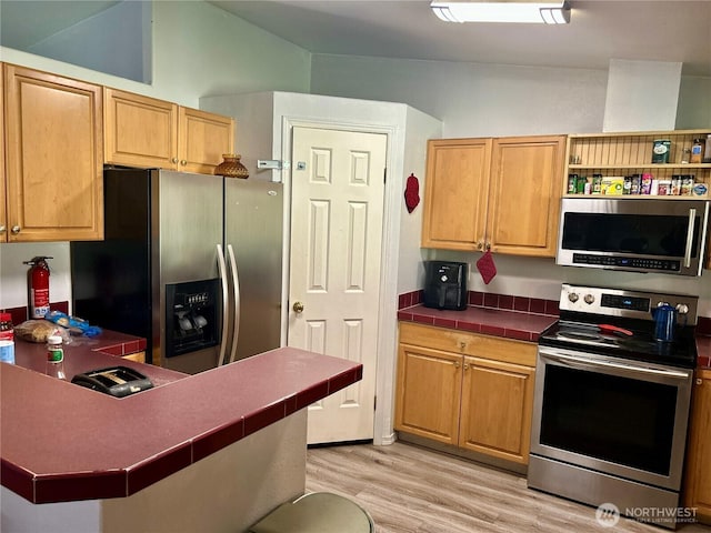 kitchen with tile countertops, light wood-style flooring, stainless steel appliances, a peninsula, and open shelves