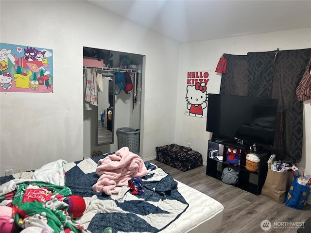 bedroom featuring a closet and wood finished floors