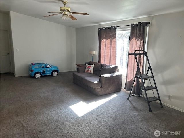 carpeted living room featuring a ceiling fan and baseboards