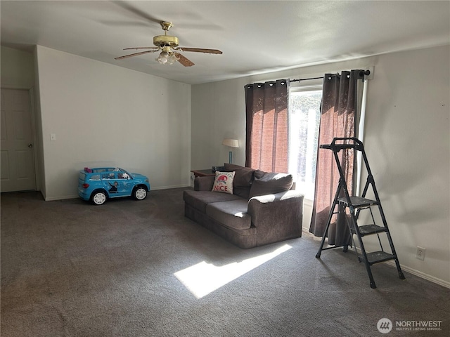 carpeted living room with a ceiling fan and baseboards