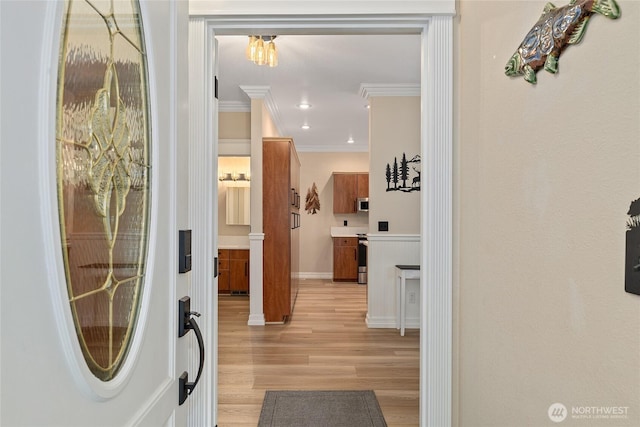 entryway featuring recessed lighting, light wood-style flooring, and ornamental molding