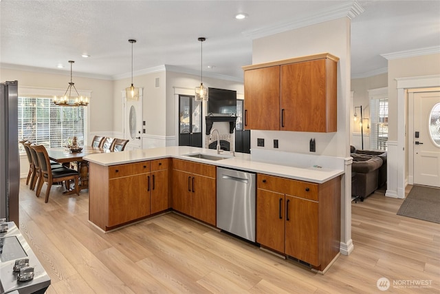 kitchen featuring a sink, stainless steel dishwasher, a peninsula, crown molding, and light countertops