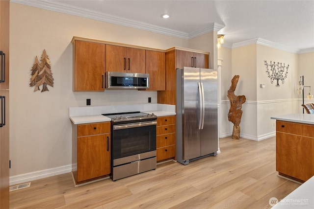 kitchen with brown cabinetry, light wood finished floors, and stainless steel appliances