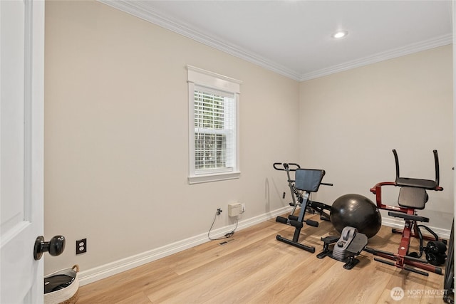 exercise area featuring baseboards, wood finished floors, and crown molding