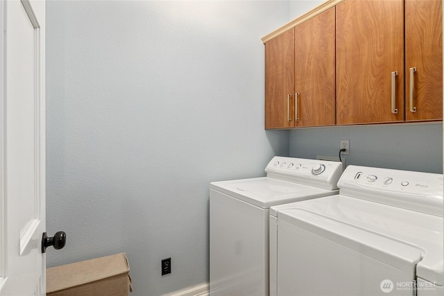 laundry room featuring cabinet space and washing machine and dryer